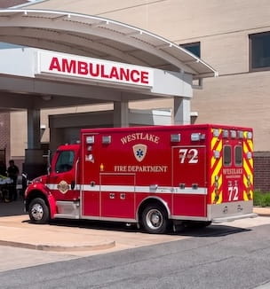Thumbnail image of an ambulance parked by an emergency room entrance.