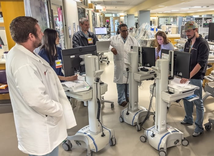 A doctor meets with his clinical care team.