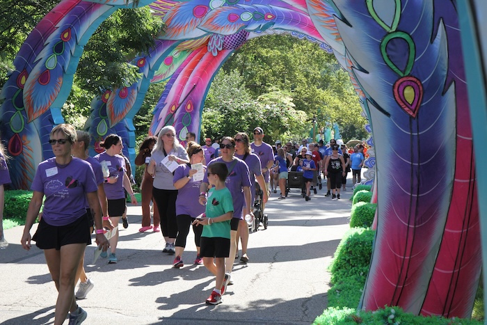 Image of people participating in a colorful walk event to support grieving parewnts.