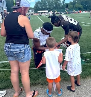 Thumbnail image of Browns players with young fans at Browns Camp.