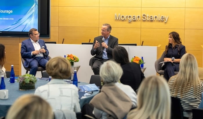Former UK Primer Minister David Cameron sits on a Morgan Stanley panel before an audience.