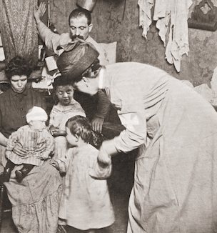Thumbnail of historic photo showing a nurse visiting the home of a poor immigrant family in the 1900s.