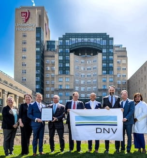 Thumbnail image of people holding ISO 9001 banner in front of UH Cleveland Medical Center.