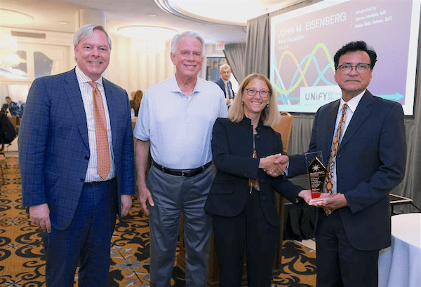 Dr. Charles Macias receiving the Eisenberg Award.