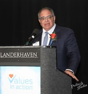 Dr. Megerian delivering remarks from a podium.