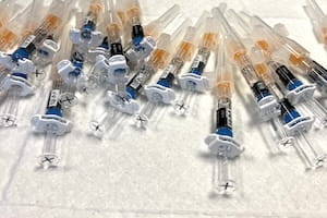 Image of vaccine syringes.