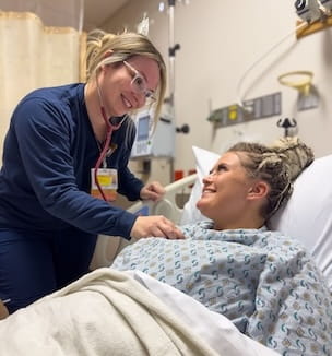 Thumbnail of a smiling nurse listening to the heart of a patient in the hospital.