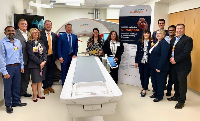 UH and Siemens team members stand around the newly installed CT machine.