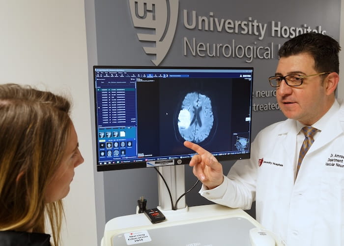 Dr. Amrou Sarraj shows a braiN scan to Kelly Montgomery of the UH Neurological Institute.