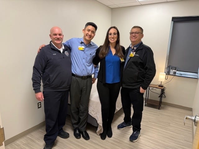 Image of several Seven Hills Fire Department members standing in new sleeping quarters.