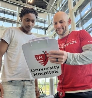 Thumbnail image of qa high school athlete reviewing results with a UH sports medicine team member.