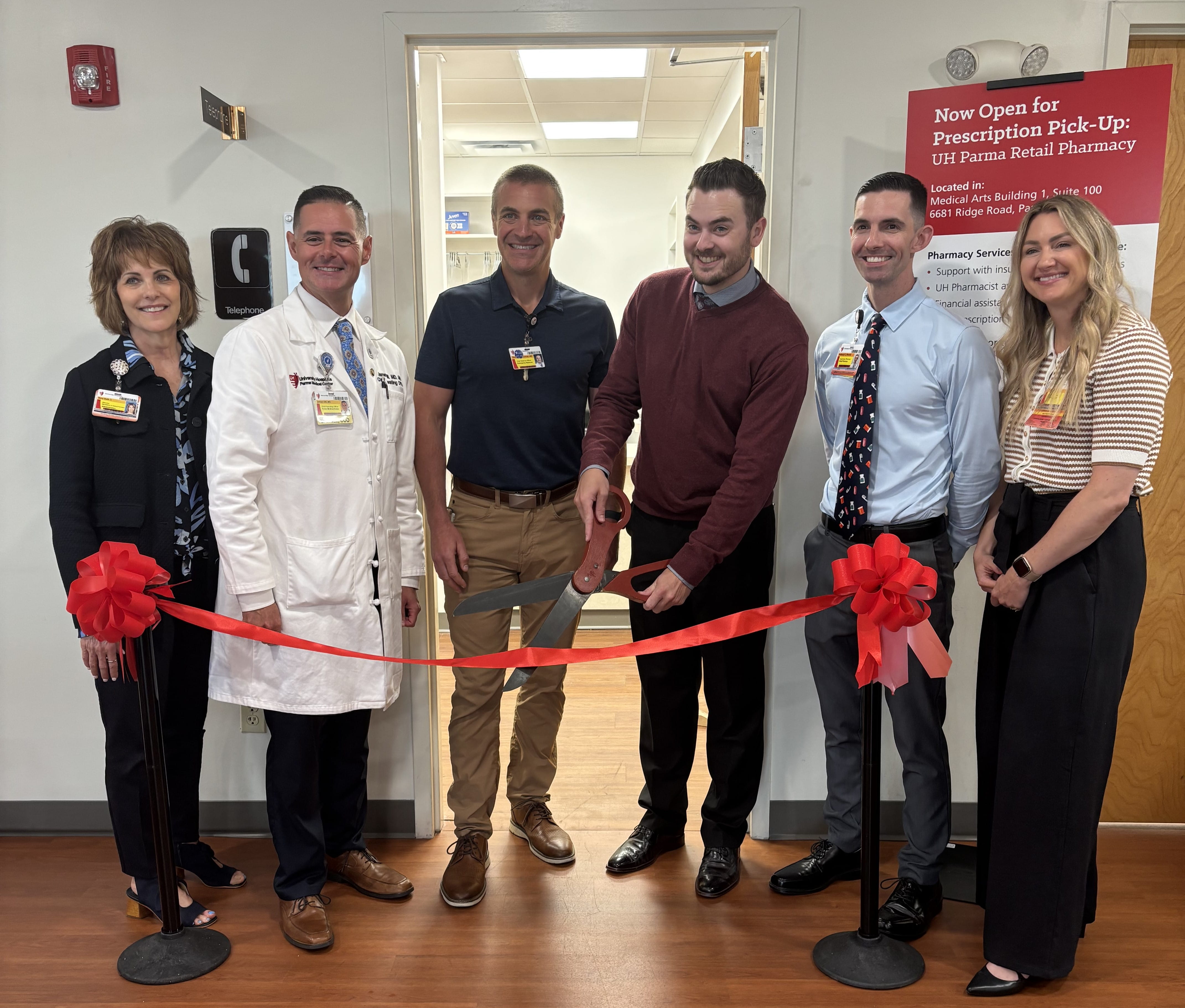 UH Parma leadership team and pharmacy team pose for photo prior to ribbon cutting at new UH Meds retail pharmacy.