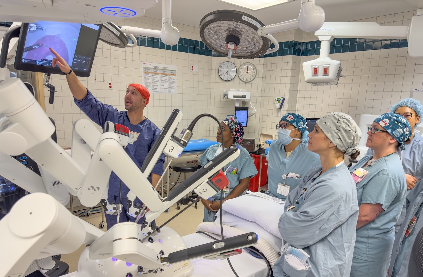 Medical staff receive instruction on the new DaVinci robot in an operating room.
